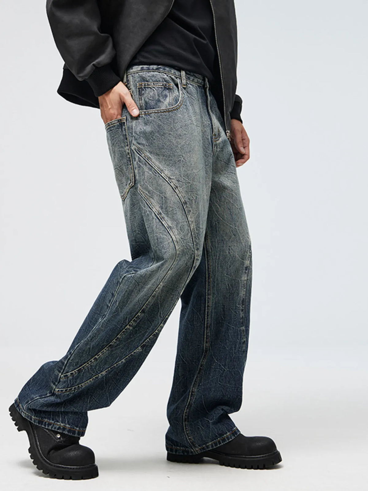 Men's wide-leg jeans in washed blue denim with contrast seam detail and cuff hems