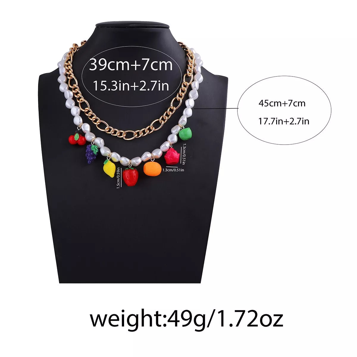 Double-layer charm necklace on black bust; gold links, white pearls, colorful fruit charms