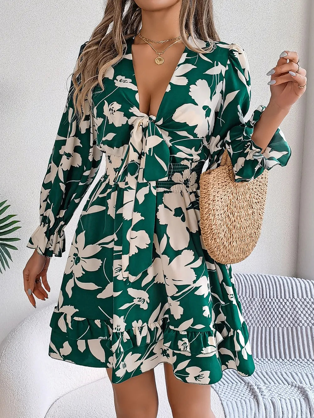 Green floral long-sleeve dress with tie-front neckline and ruffled hem