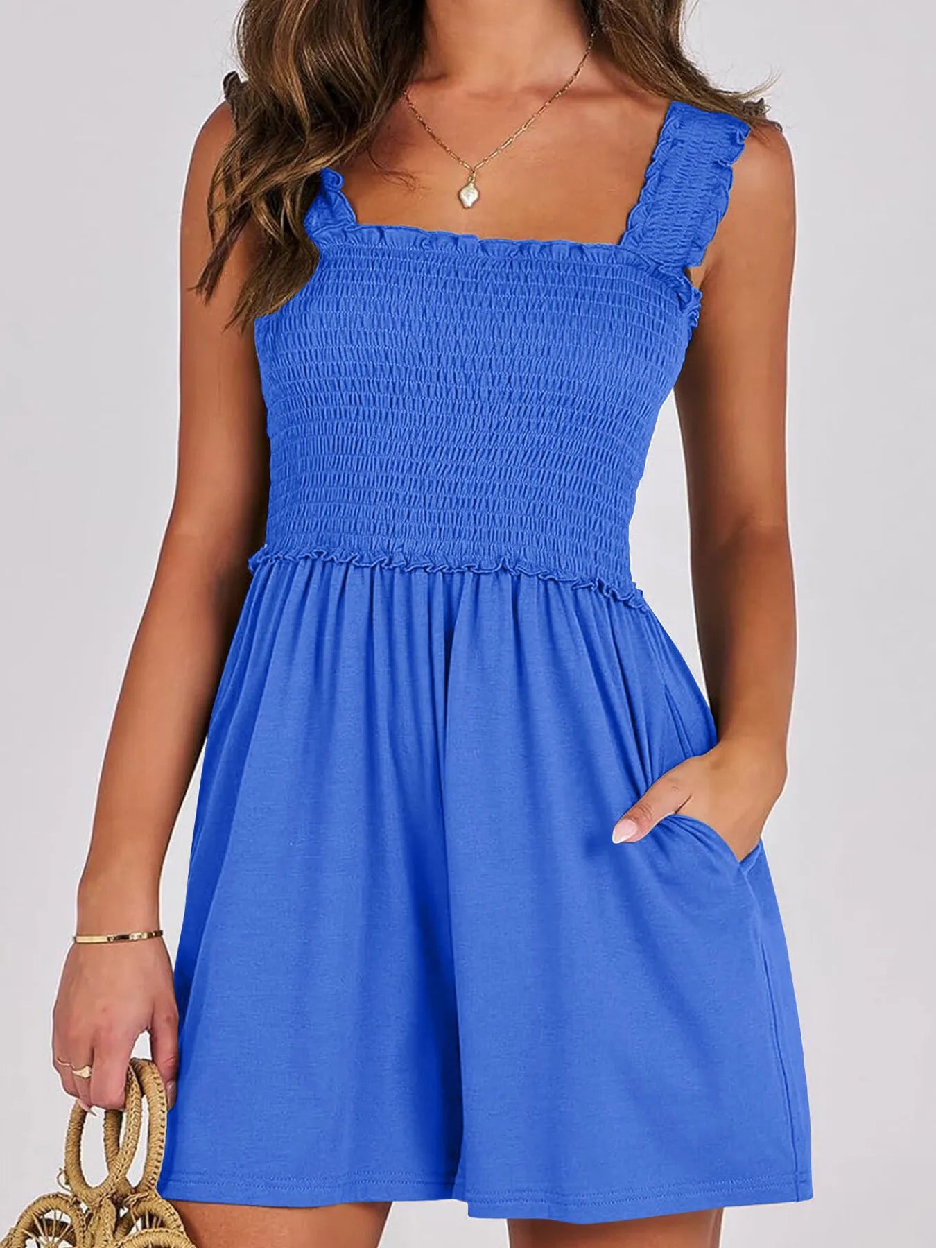 Smocked square-neck summer romper in bright blue, sleeveless with ruffled neckline and skirt