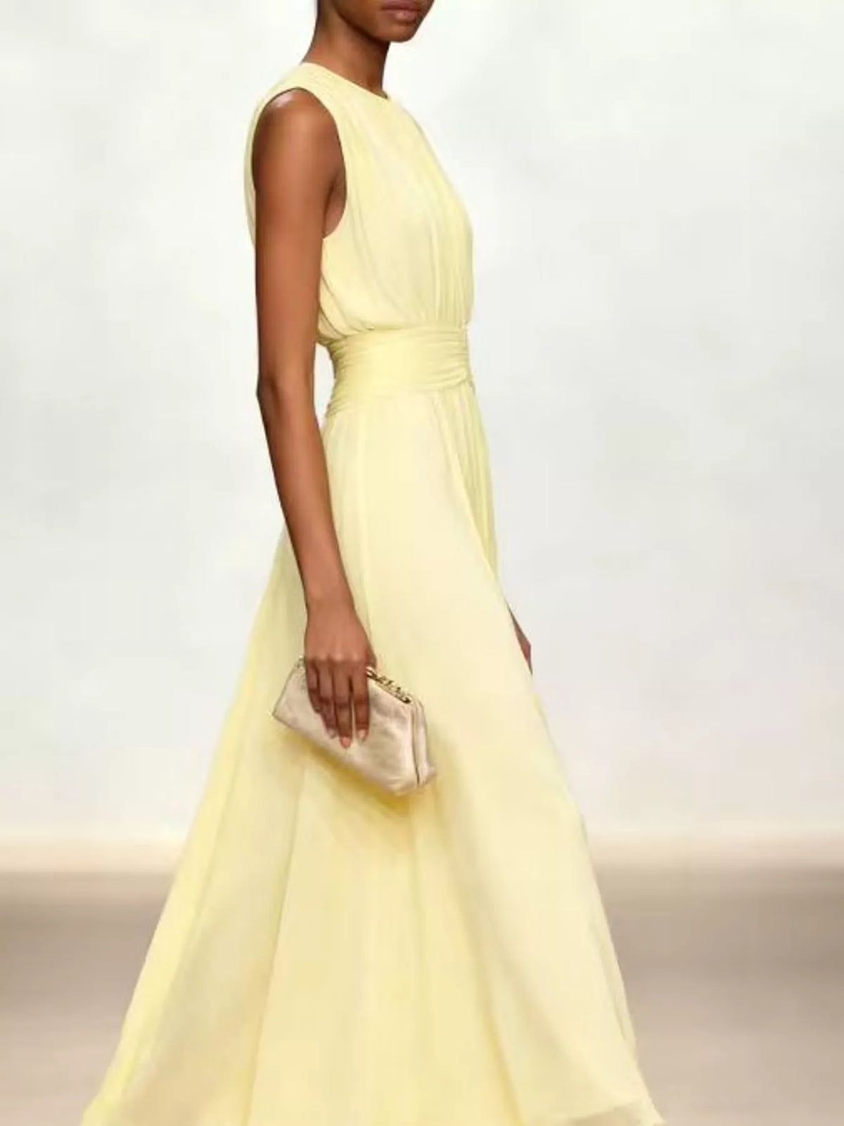 Light yellow sleeveless chiffon maxi dress with cinched waist and gathered bodice