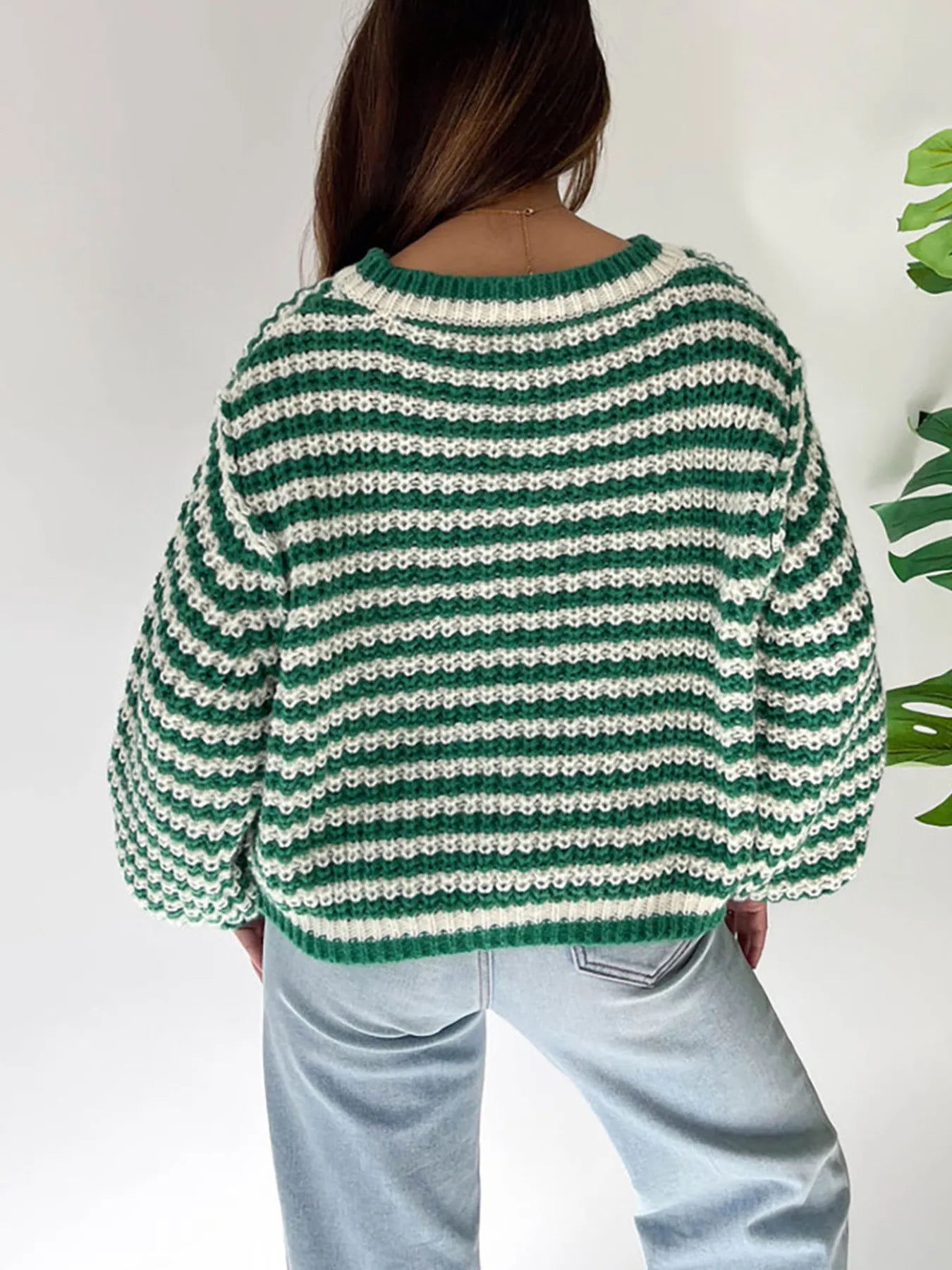 Green-and-white striped drop-shoulder sweater from back view, ribbed crew neck