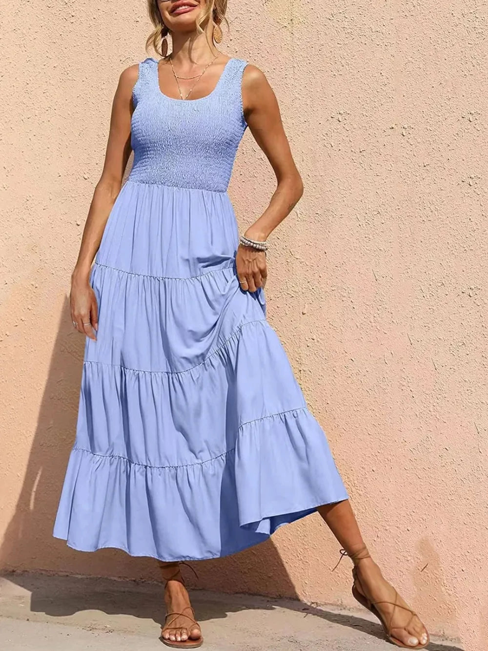 Tiered smocked wide strap dress in light blue with tiered ruffle skirt.