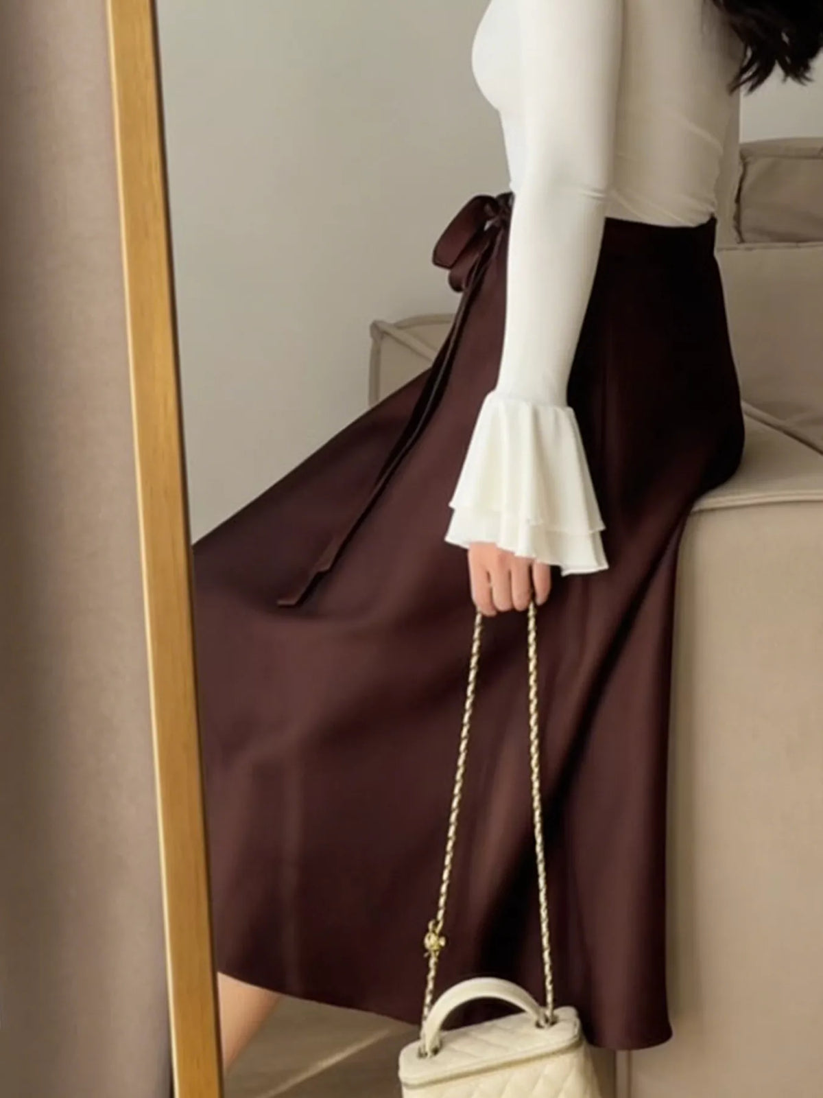 Burgundy satin A-line midi skirt with bow-tie side detail and gathered waist