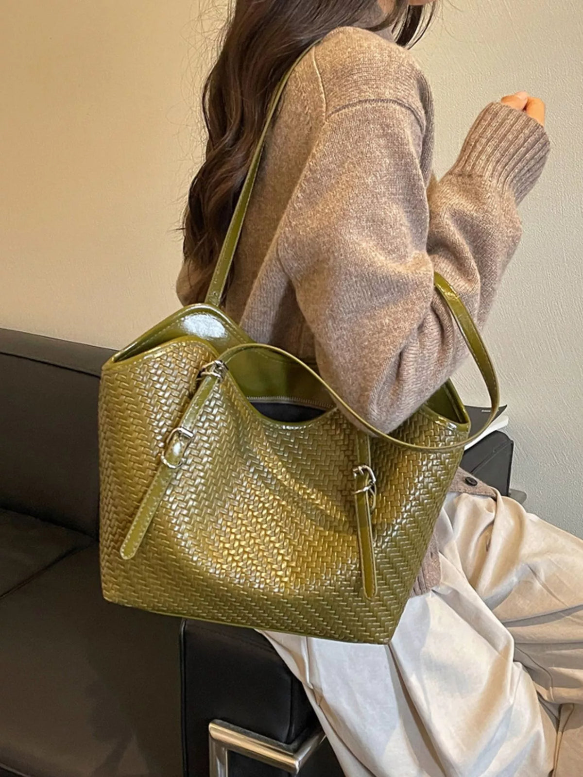 Green textured tote bag with wide opening, dual handles, and vertical zipper trim