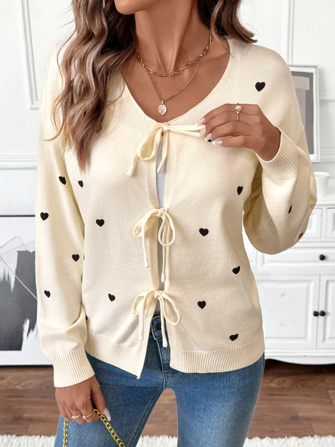 Cream heart tie-front long sleeve cardigan with V-neck bow ties and ribbed cuffs