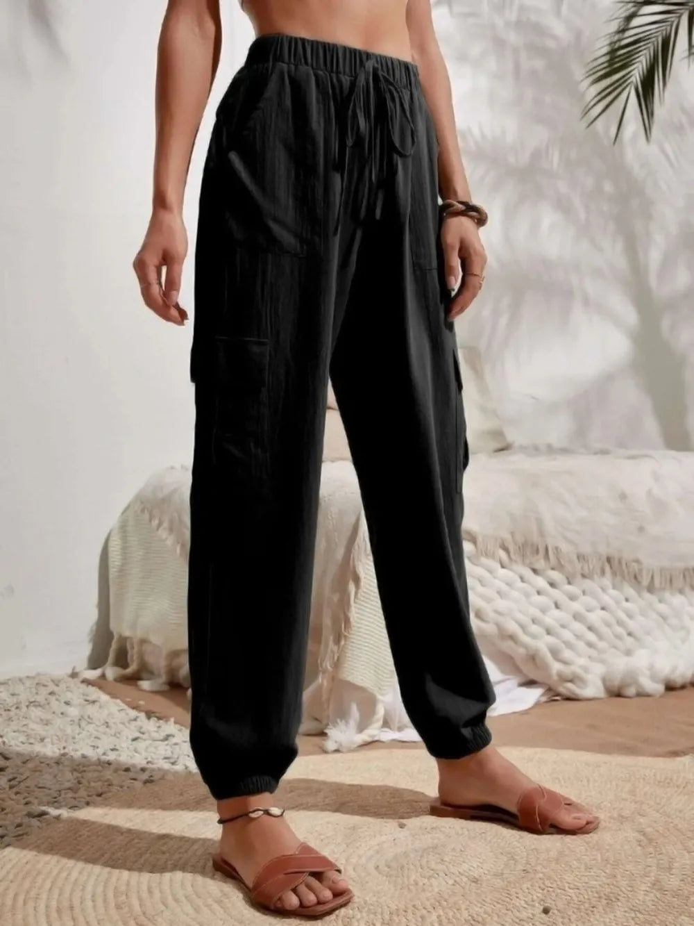 Black drawstring cargo joggers with cargo pockets and elastic ankle cuffs