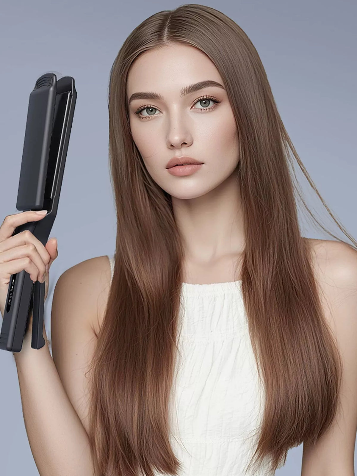 Portable heat hair straightener held beside long straight brown hair