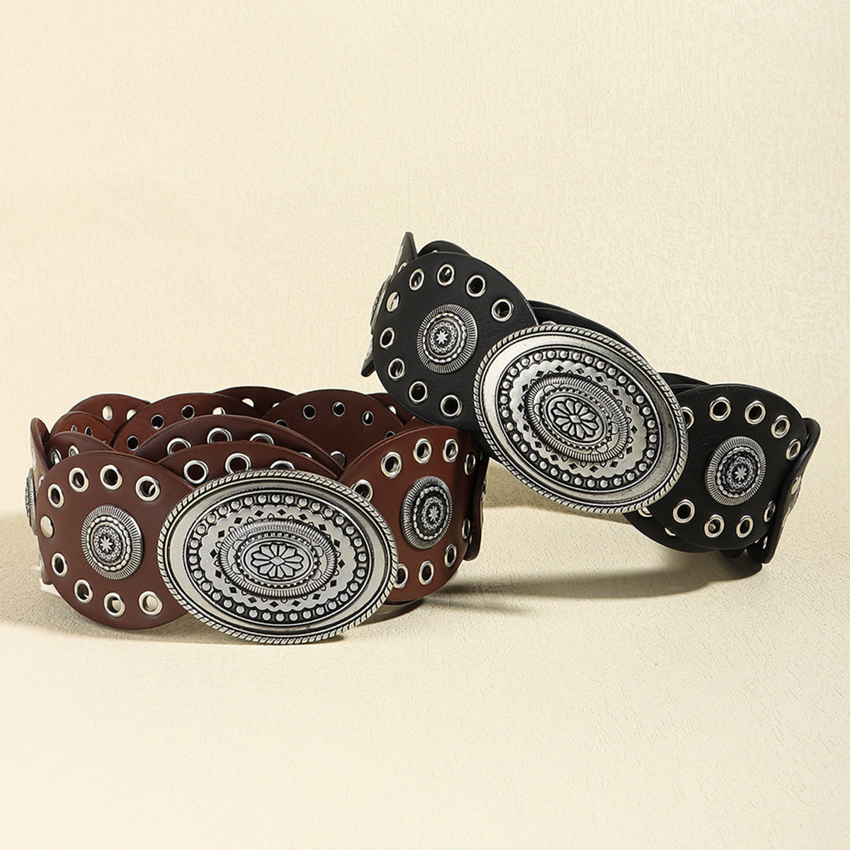 Dark brown and black vegan leather belt with silver oval buckle and stud trim