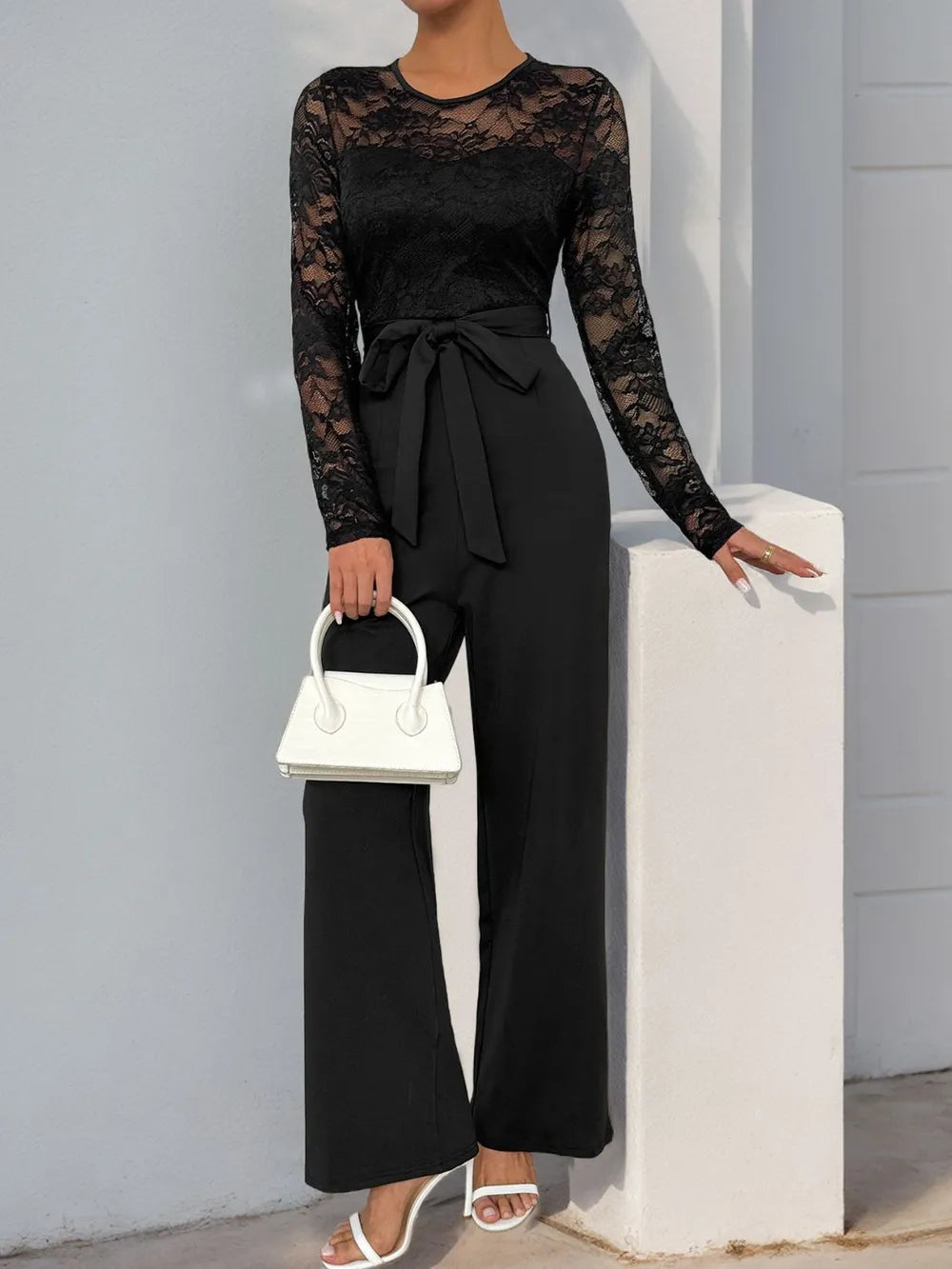 Black lace long-sleeve jumpsuit with round neck, belted waist, wide-leg pants