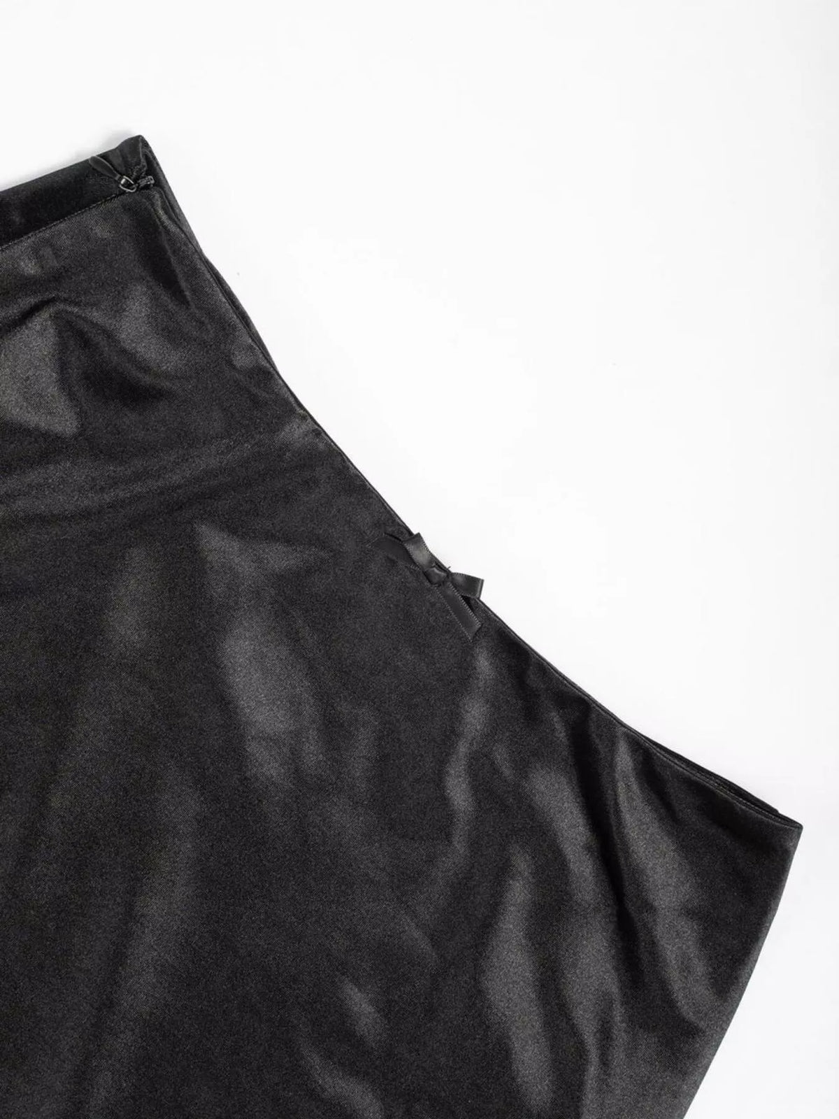 Black satin skirt fabric panel with smooth sheen and side seam