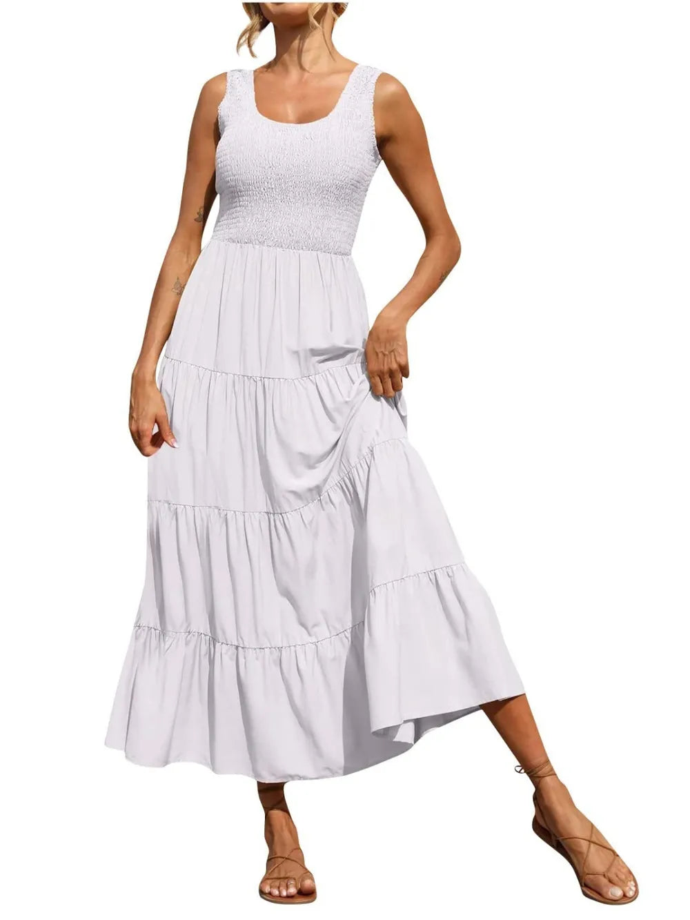 White tiered smocked wide-strap dress with sleeveless bodice and cascading tier ruffle skirt.
