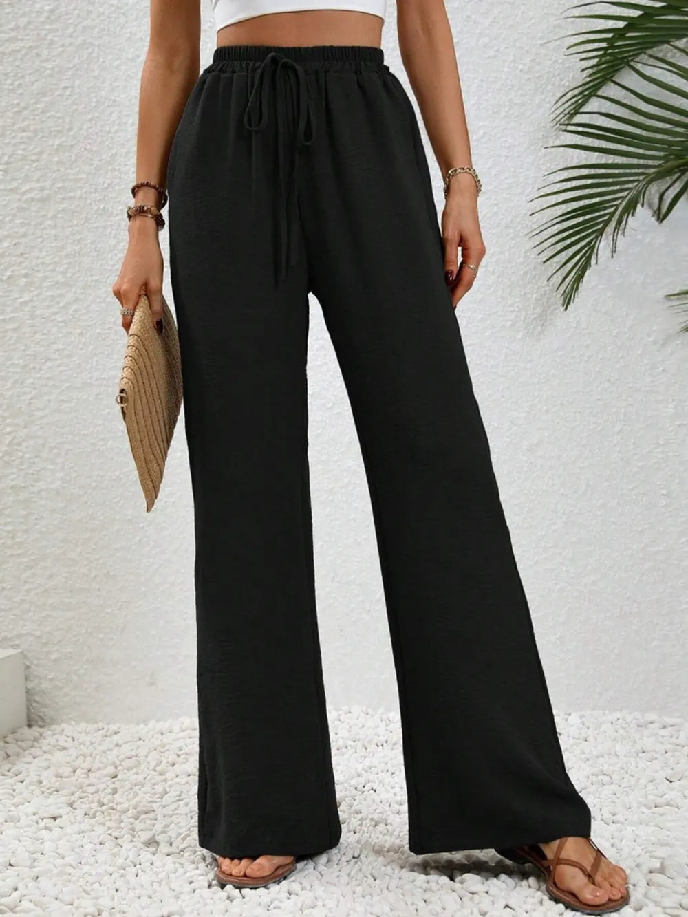 Black wide-leg drawstring pants with elastic waist and roomy straight legs
