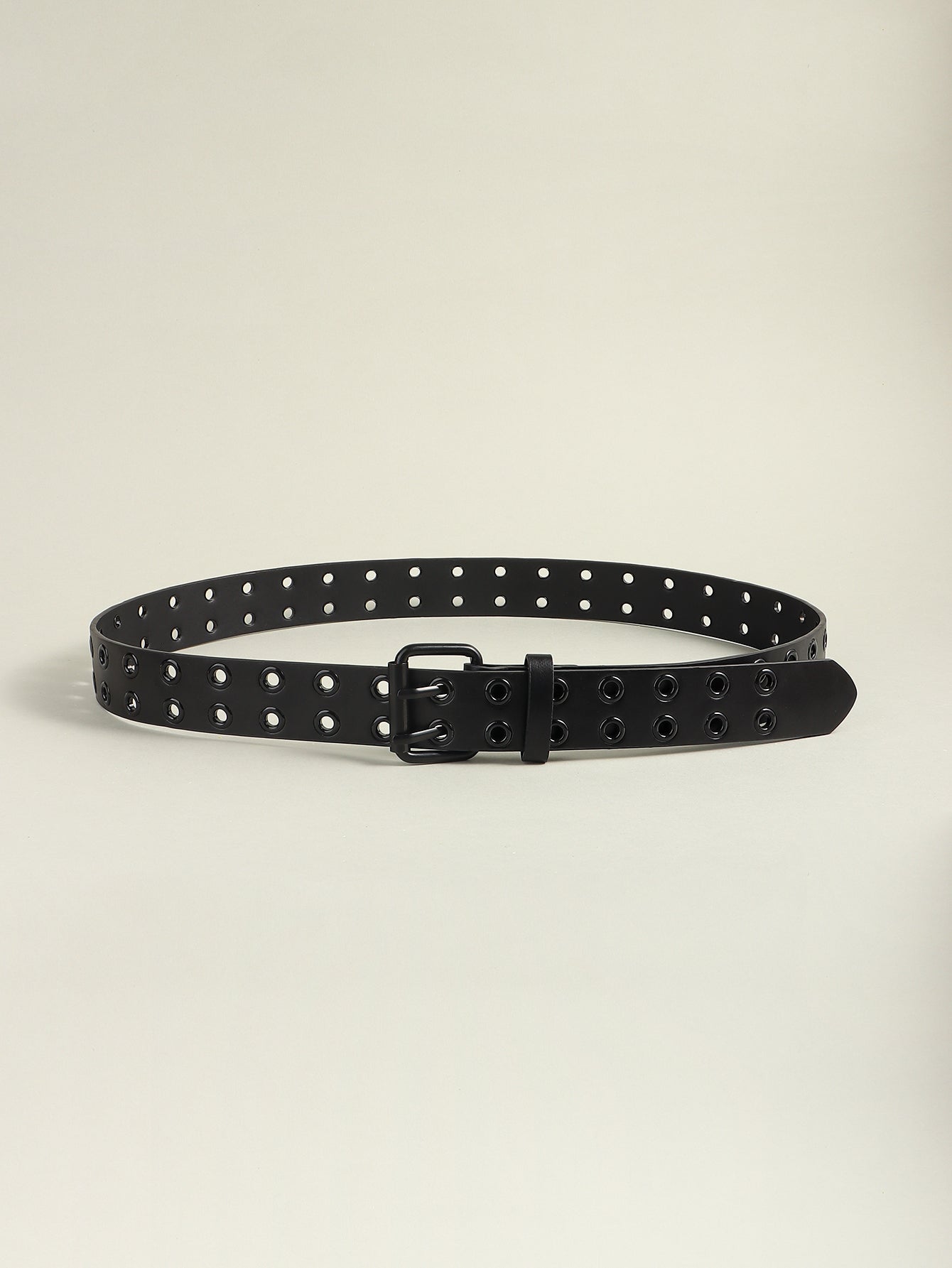 Black vegan leather grommet belt laid flat with square buckle and studded holes