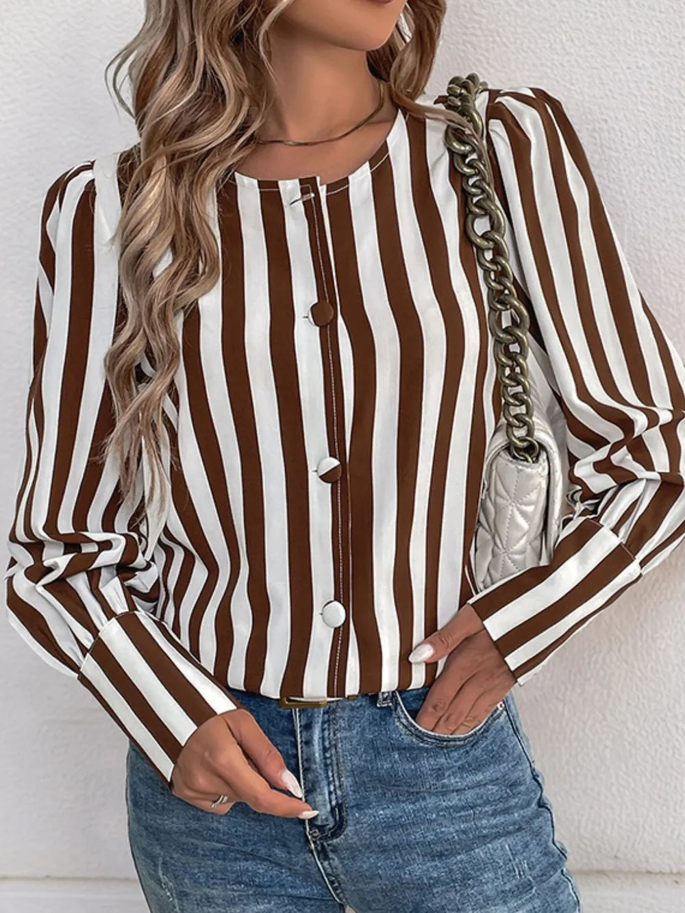 Brown and white striped long-sleeve blouse with round neckline and front buttons