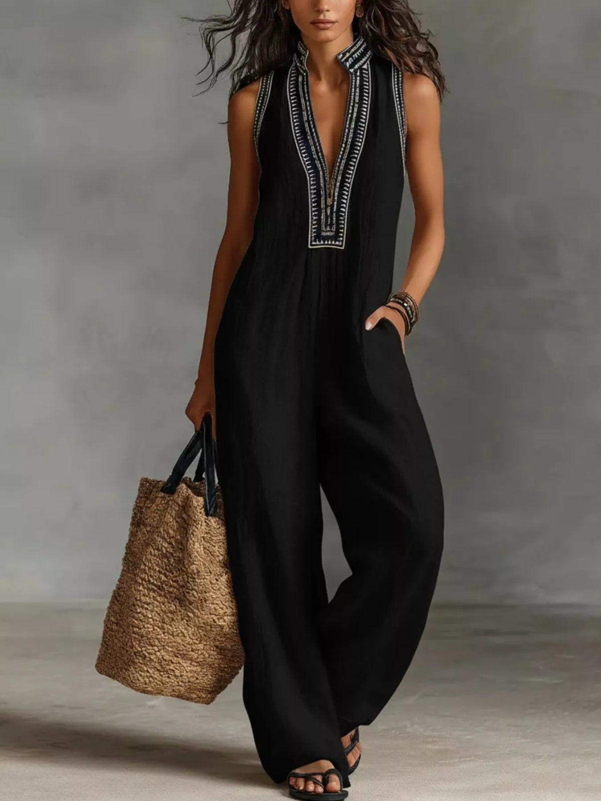 Black sleeveless wide-leg jumpsuit with V-neck and dark embroidered trim