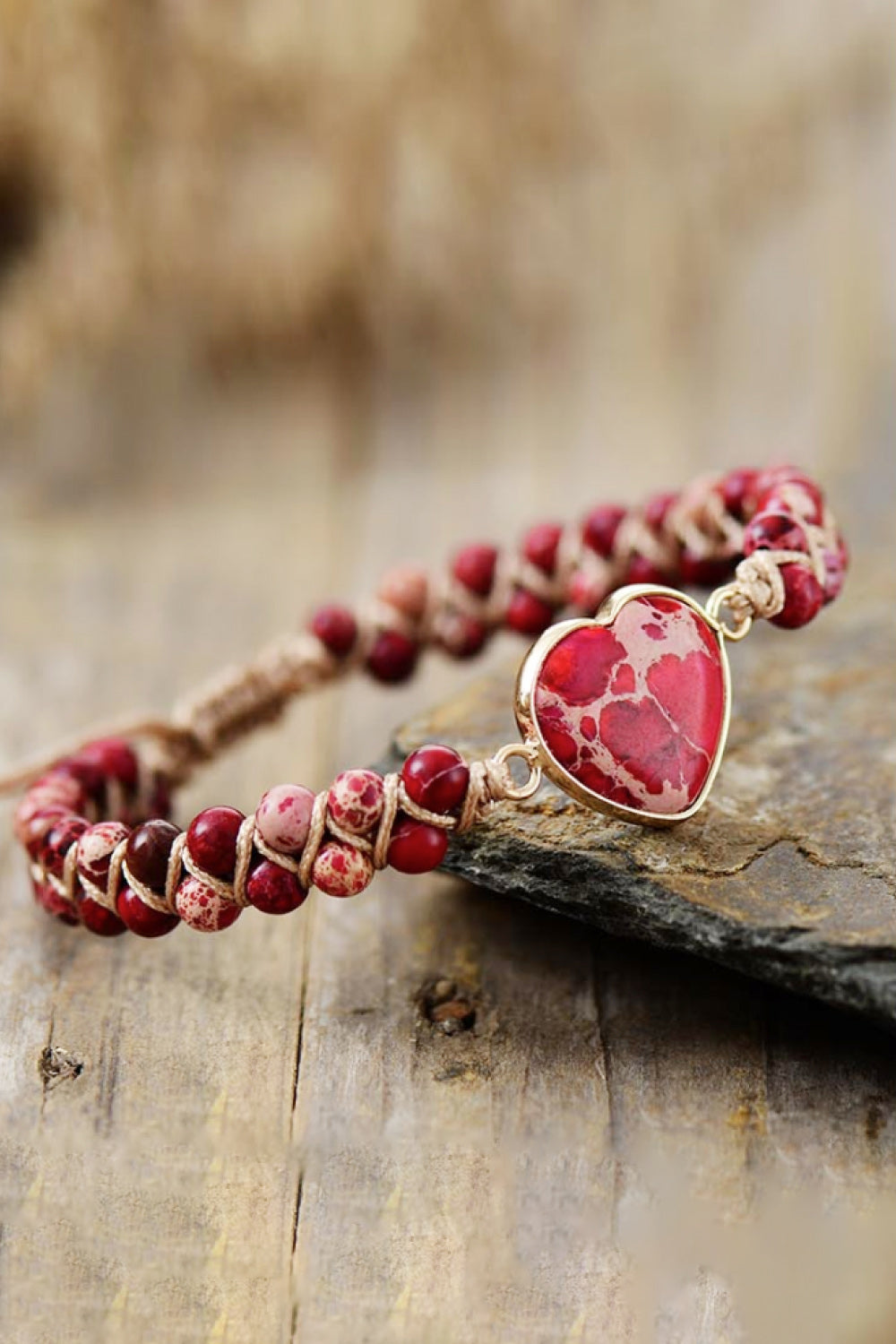 Red beaded heart bracelet with oval red heart pendant and braided cord adjustable fit