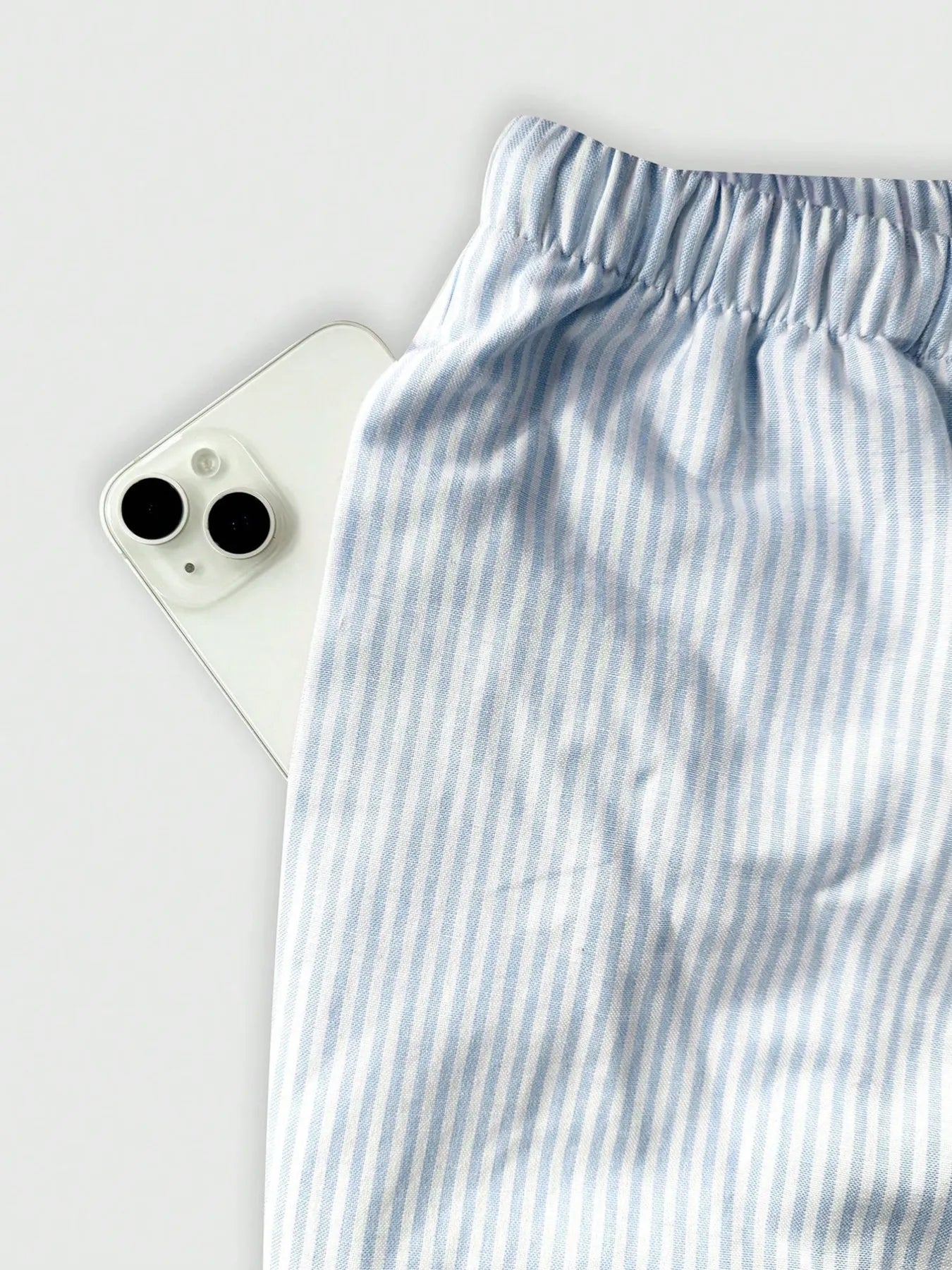 Light blue striped pants waistband with elastic band and drawstring tie cords
