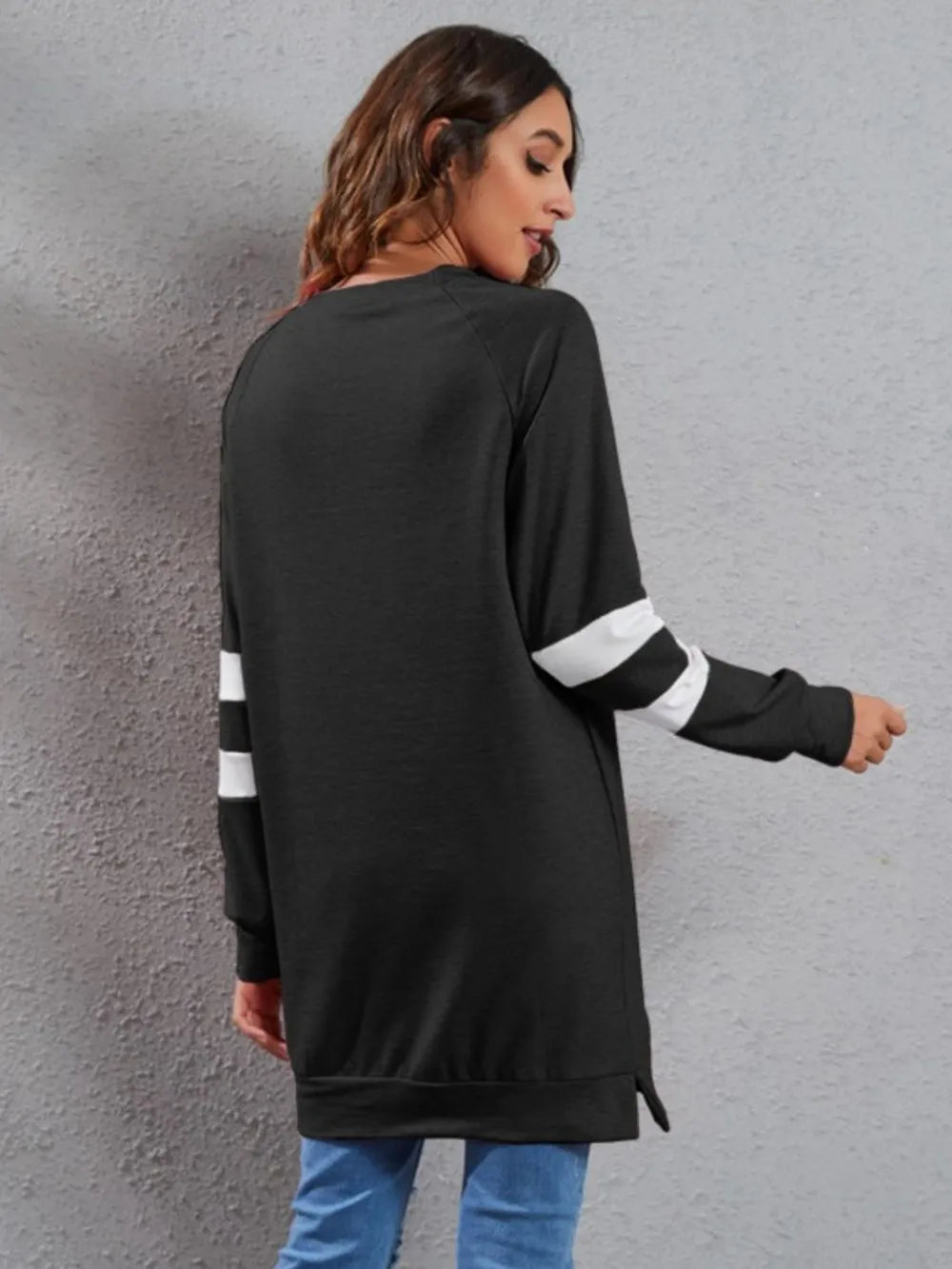 Black long-sleeve T-shirt from back with round neck and white striped cuffs