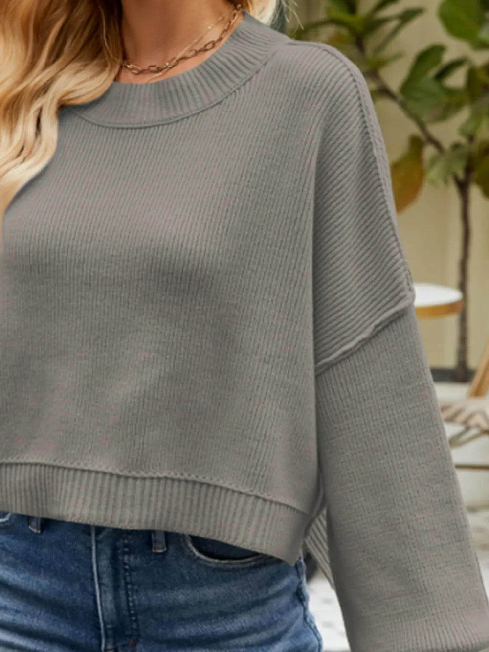 Round neck lantern-sleeve sweater in heather gray, close-up of ribbed crew neck
