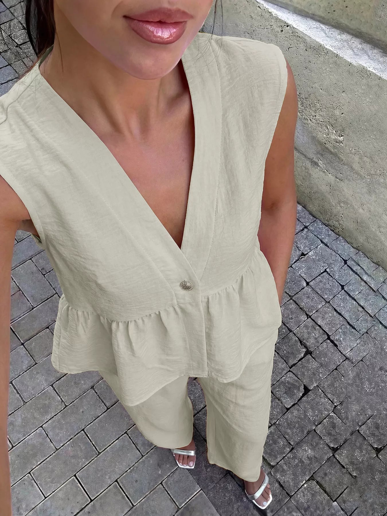 Beige peplum V-neck sleeveless top and wide-leg pants set, button front detail