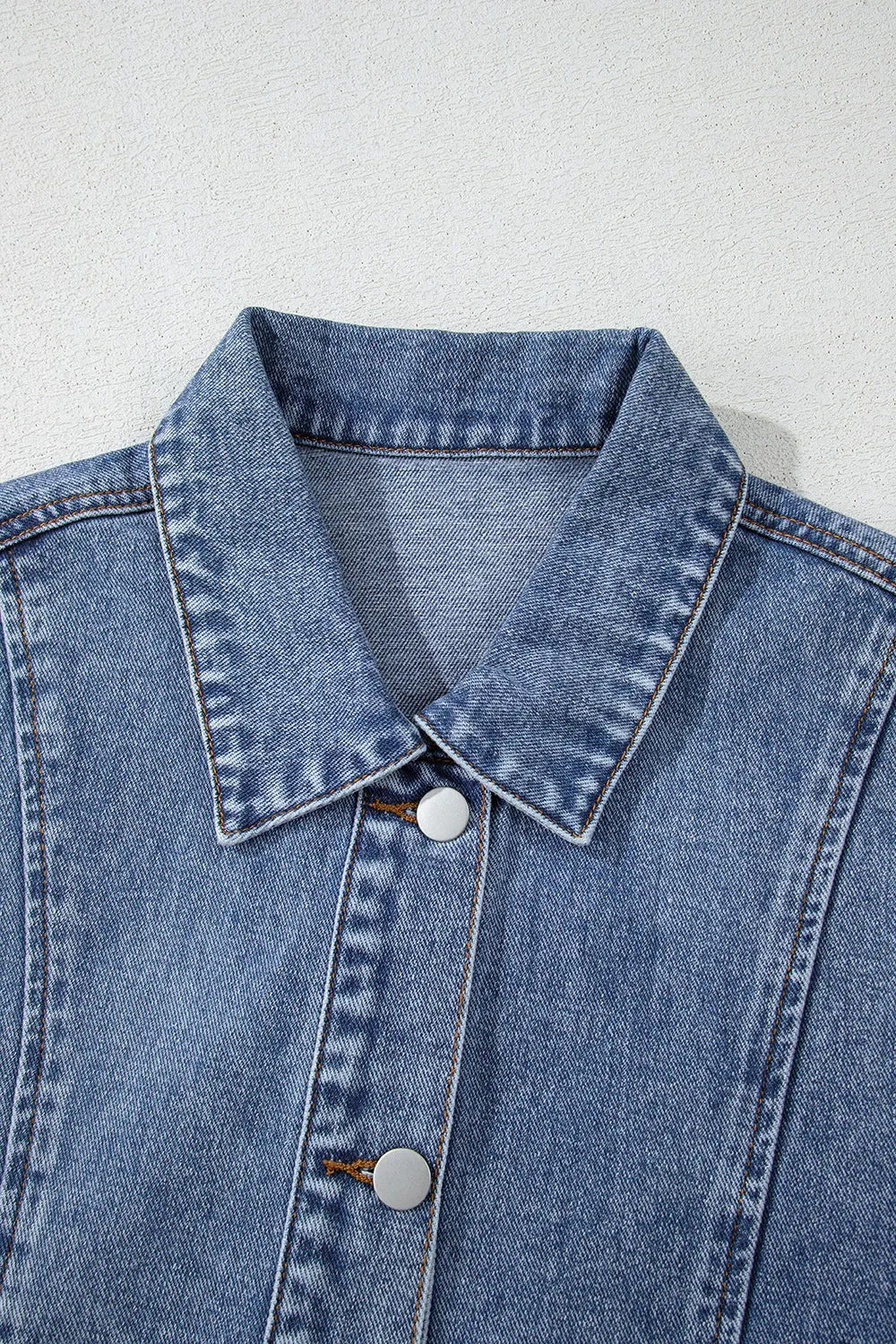 Denim button-up cap sleeve jacket with pointed collar and front snap buttons