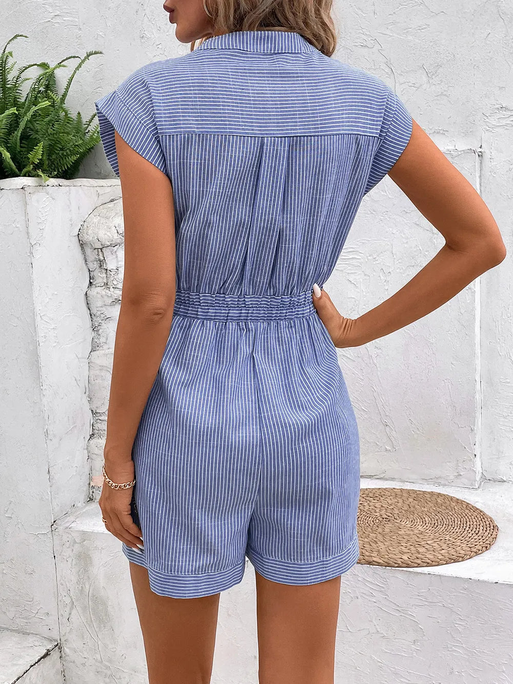 Light blue striped romper back view, tie waist, buttoned back, short sleeves