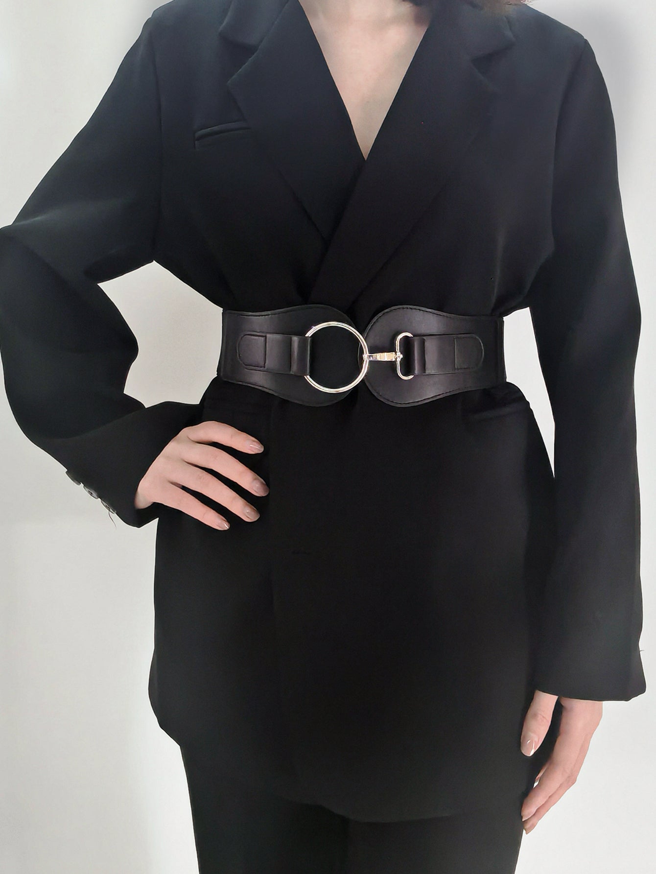 Black vegan leather wide elastic belt with O-ring buckle centered at the waist