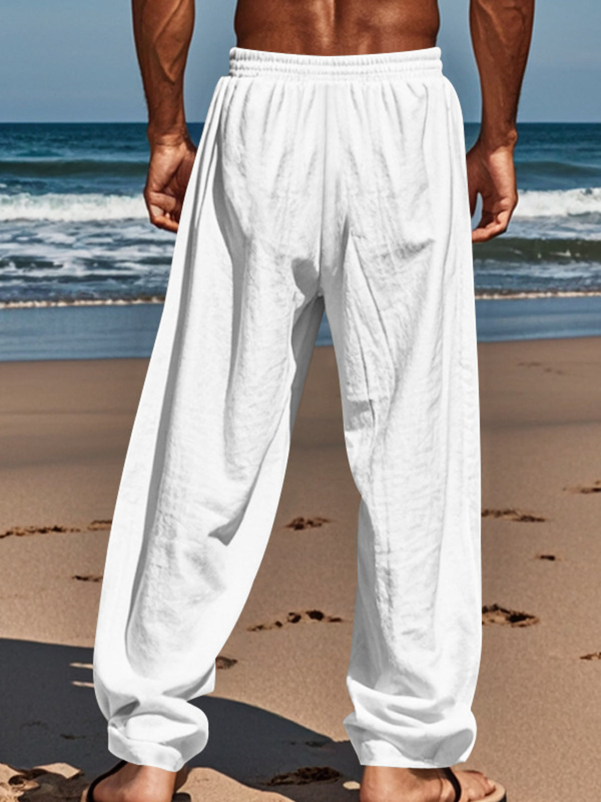 Men's loose-fit drawstring pants in white, roomy leg openings with gathered cuffs