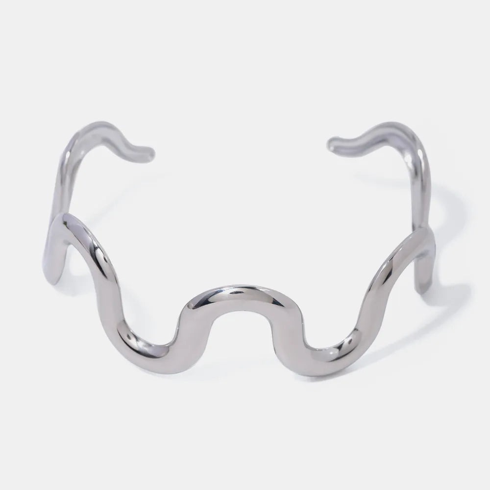 Wave-shaped stainless steel bracelet, open cuff with symmetrical wavy loops, silver.