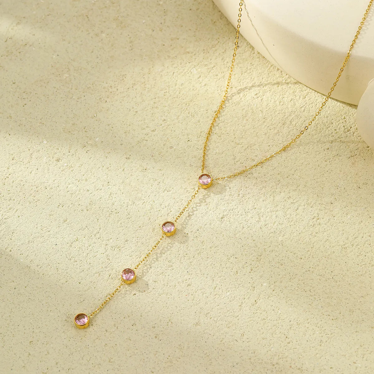 Gold-plated zircon Y-drop necklace with pink round stones along the Y drop