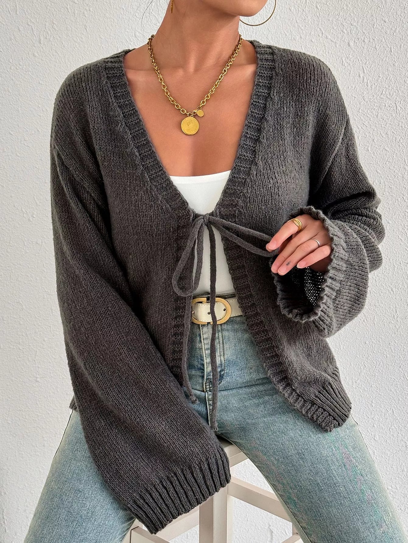Dark gray tie-front cardigan with V-neck and long sleeves, ribbed hem and cuffs