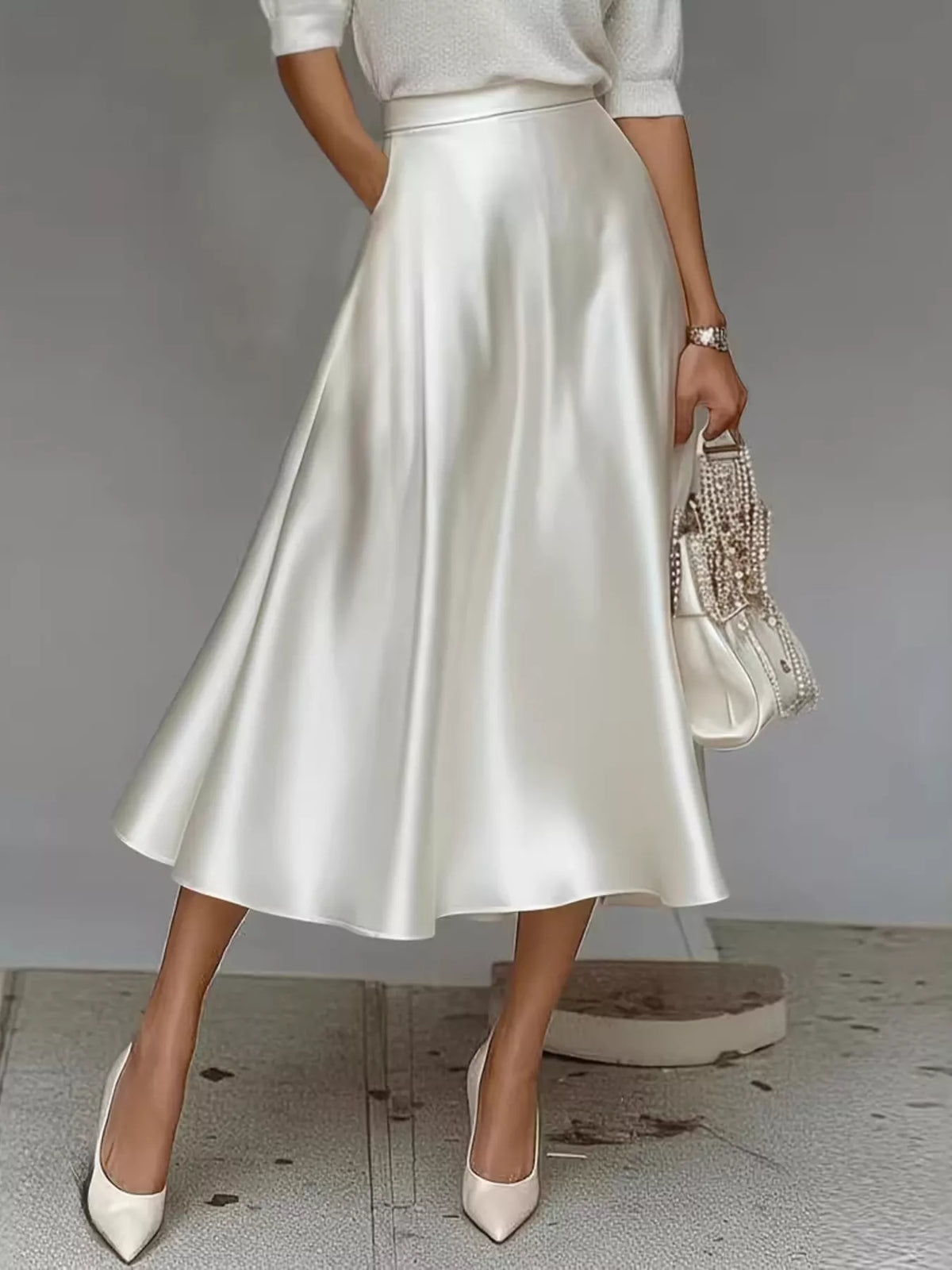 High-waist satin midi skirt in white, A-line silhouette with smooth glossy fabric.