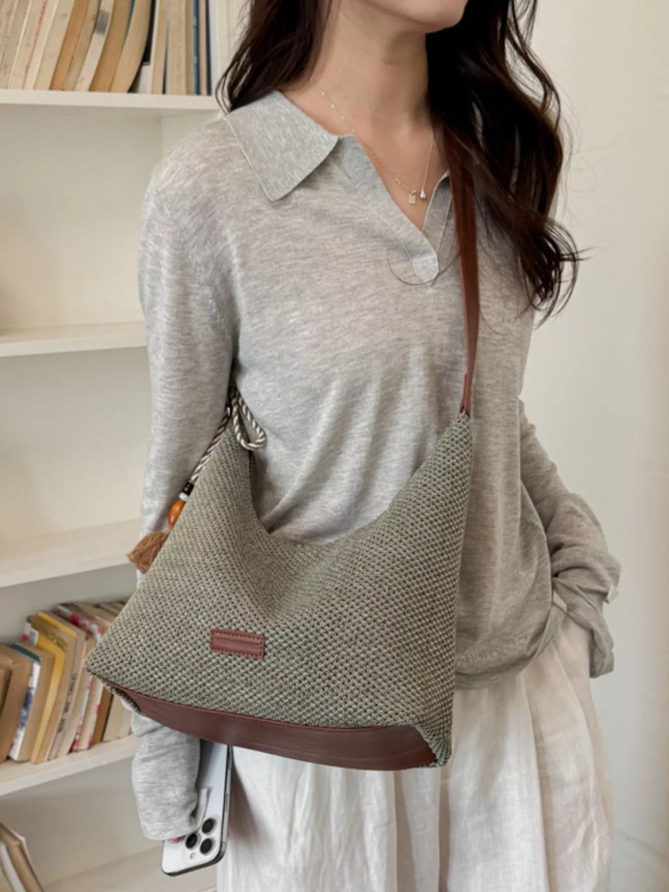 Medium woven shoulder bag worn crossbody, textured gray woven fabric and tassel pull