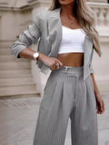 Light gray pinstripe cropped blazer and wide-leg pants set with matching belt
