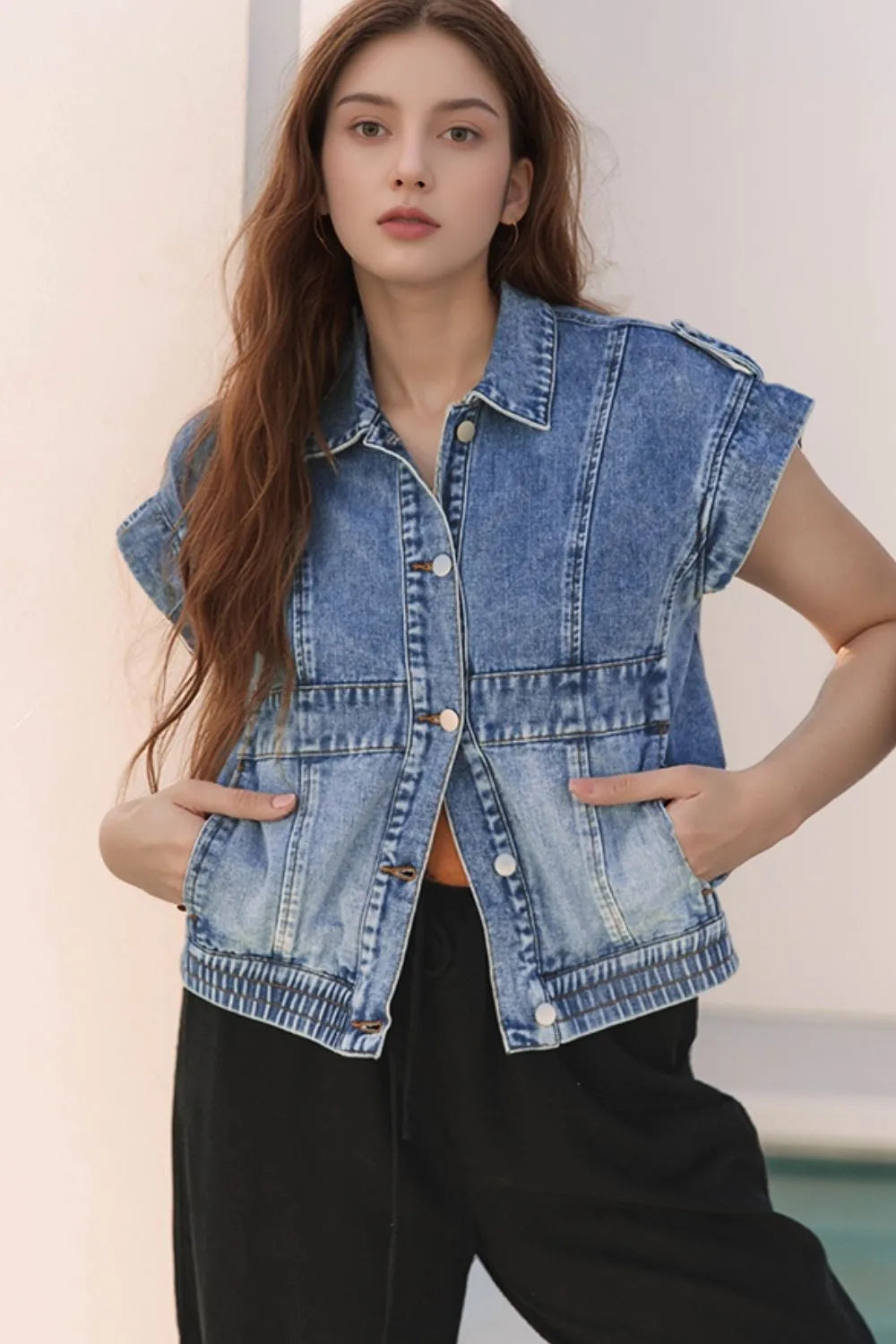 Medium-wash denim button-up cap sleeve jacket with front pockets and gold-tone buttons