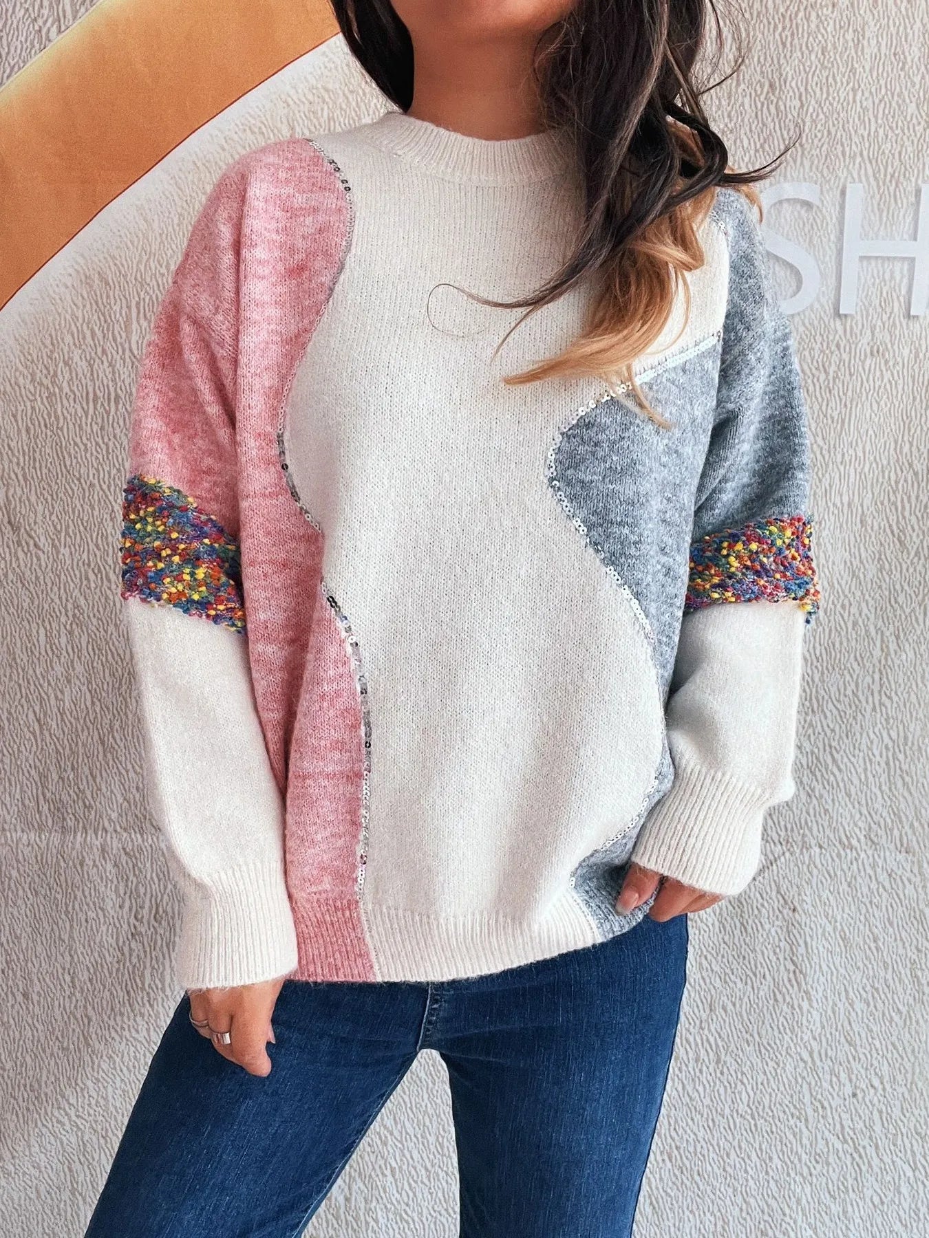 Dropped shoulder sweater: white knit with pink sleeve, blue panel, colorful speckled cuffs