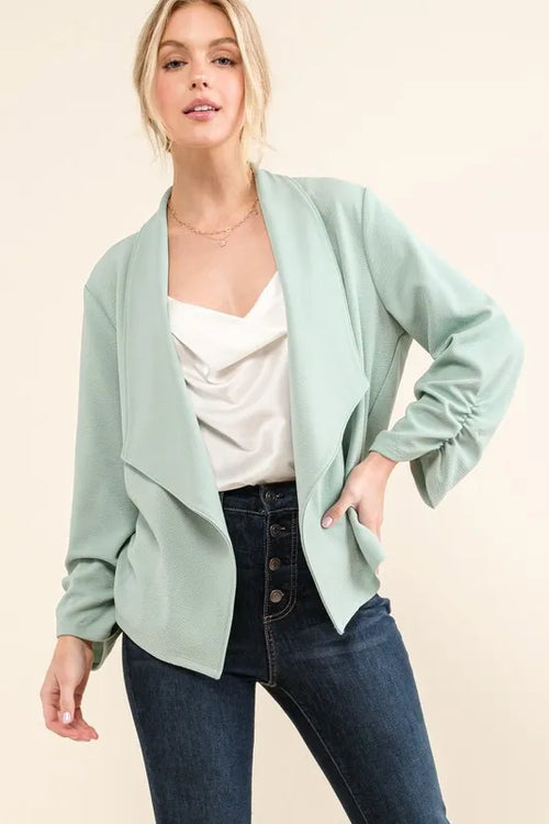 Mint open-front blazer with long sleeves and angled front panels