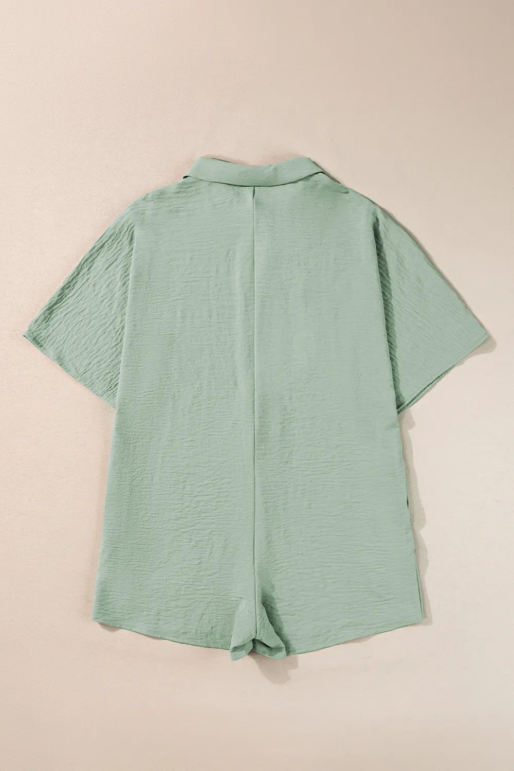 Sage green collared romper with half-button placket and short sleeves