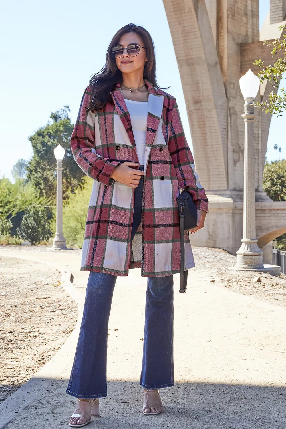 Plaid button-up lapel coat in red and cream, long sleeves, front view.