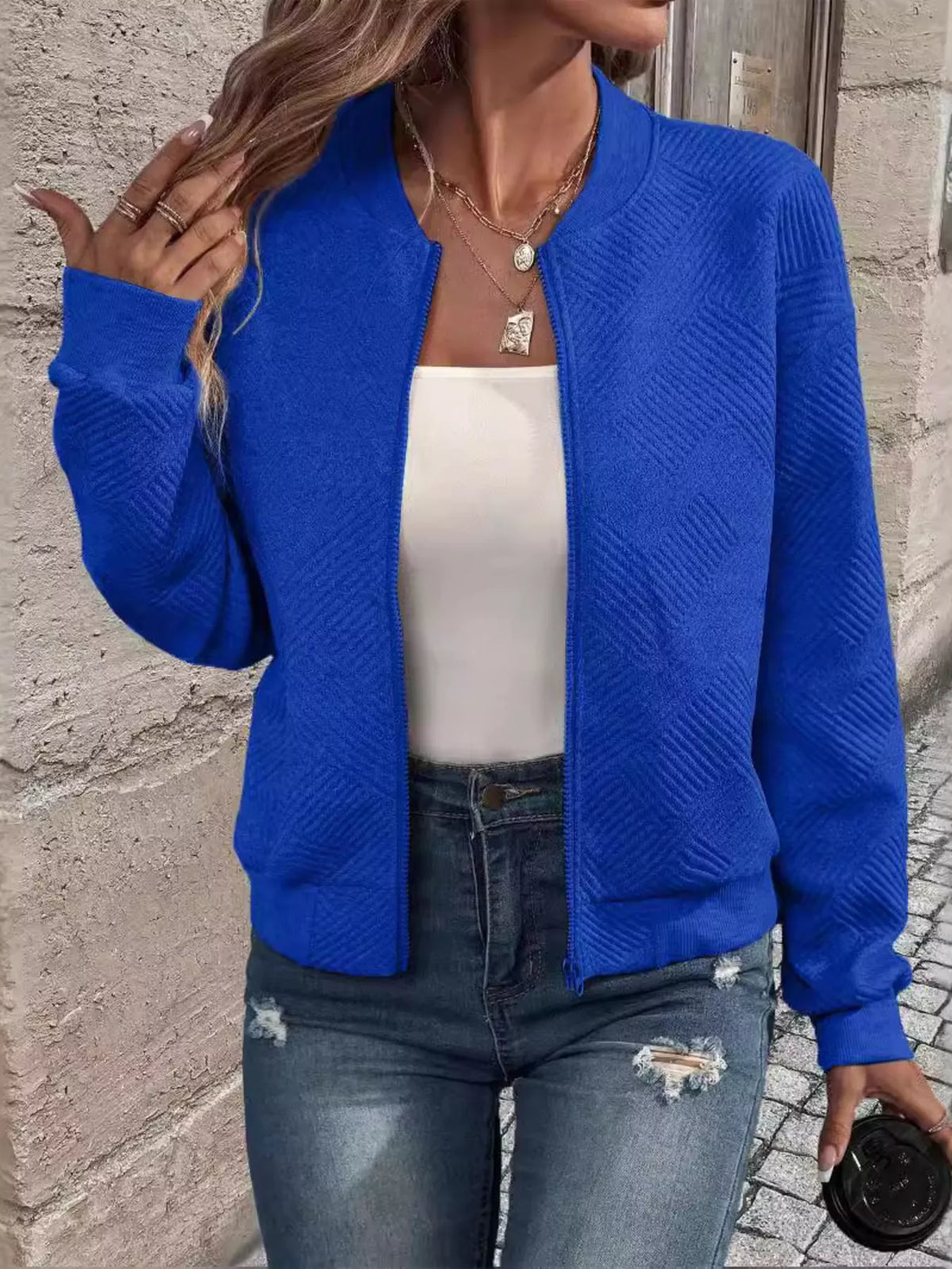 Blue textured knit zip-up jacket with long sleeves and front pockets