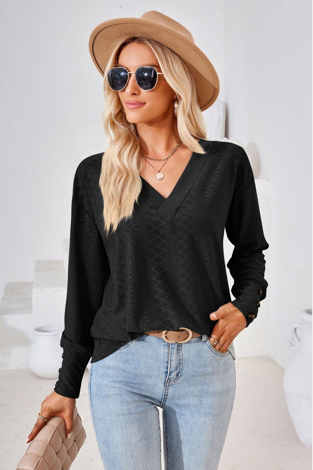 Black V-neck long-sleeve blouse with textured diamond pattern and relaxed fit