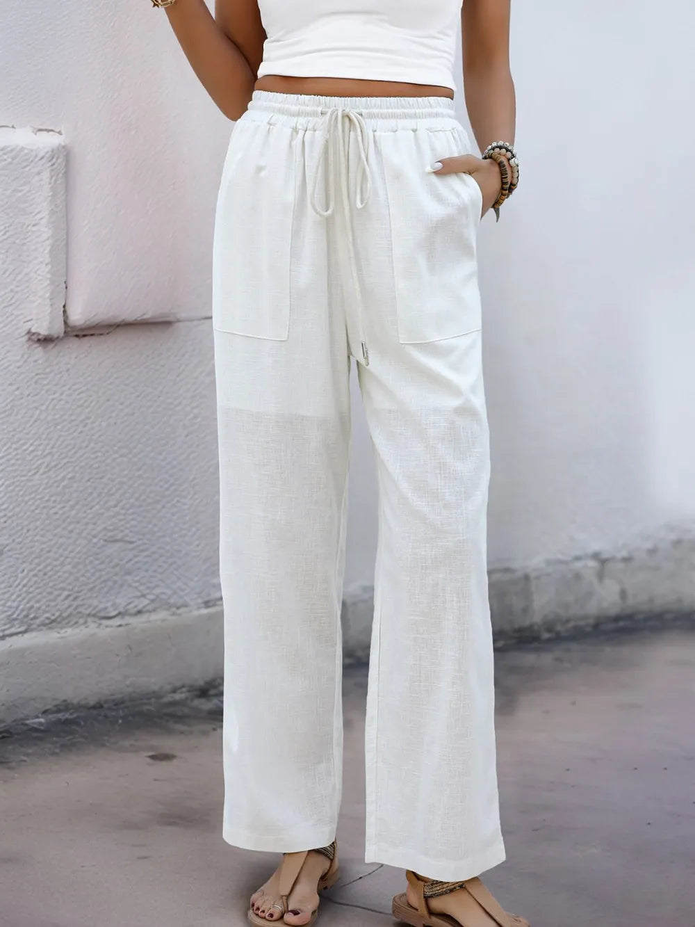 White wide-leg drawstring pants with elastic waist and two front pockets