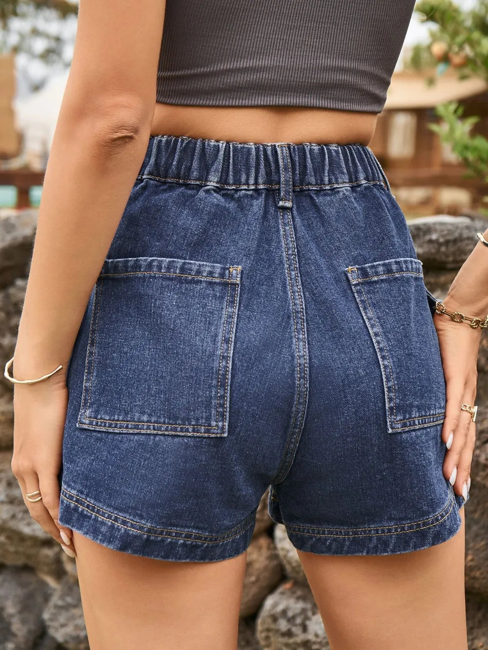 High-waist dark blue denim shorts with belt loops, front button, and two front pockets