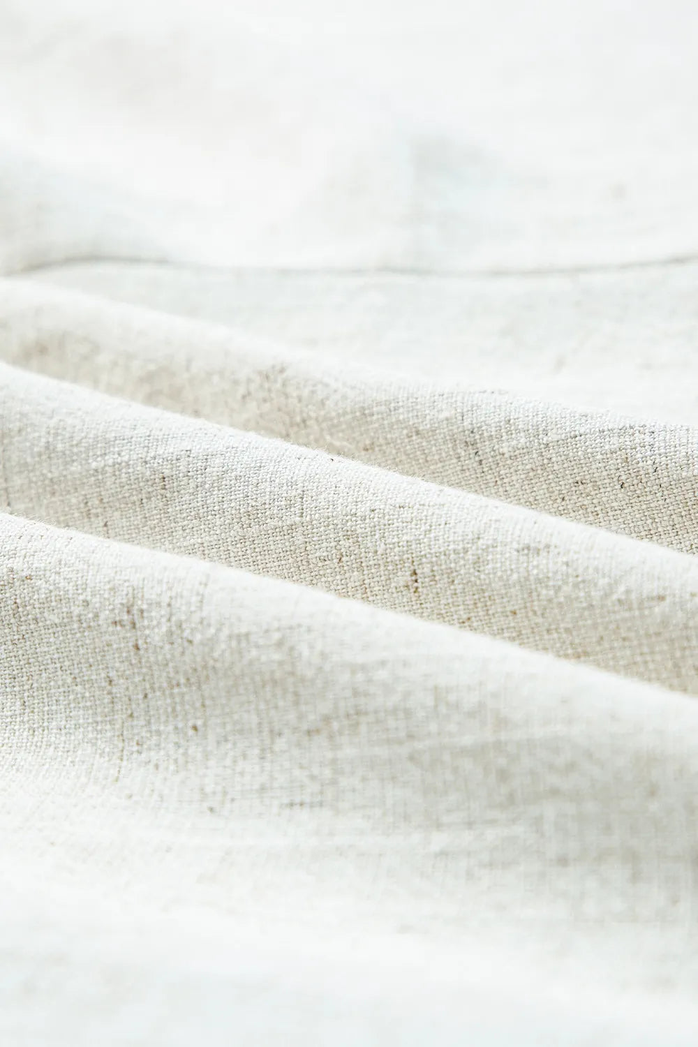 Light beige woven fabric with soft texture, drape and subtle slub