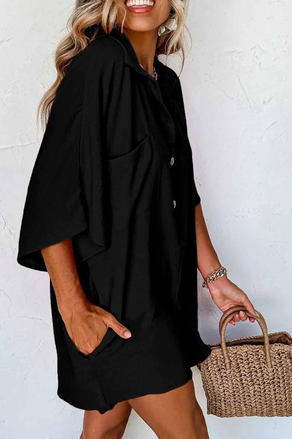 Black collared romper with half-button placket and short sleeves