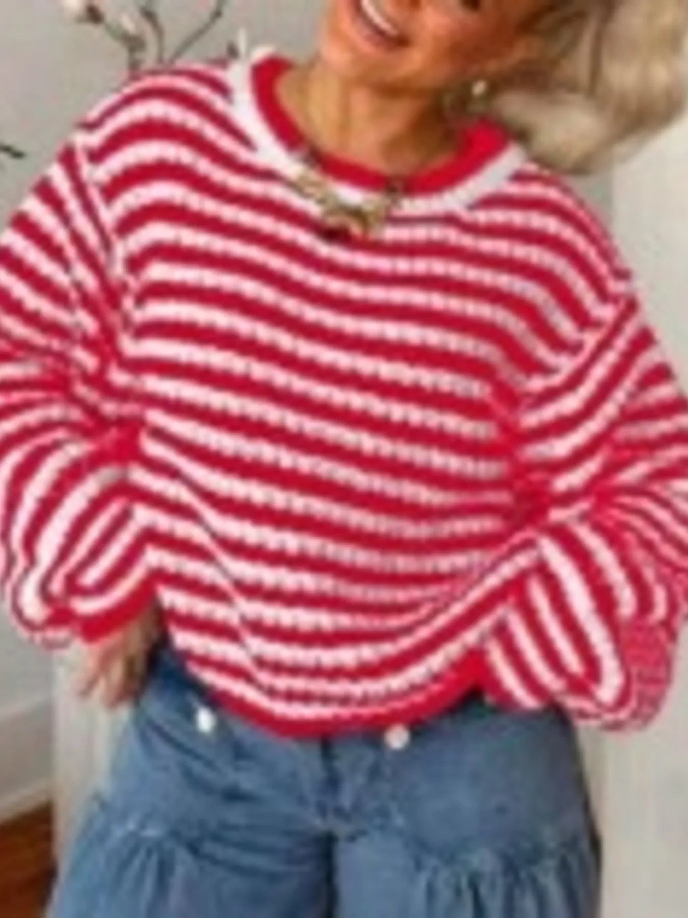 Red and white striped knit sweater with wide sleeves and ribbed crew neckline