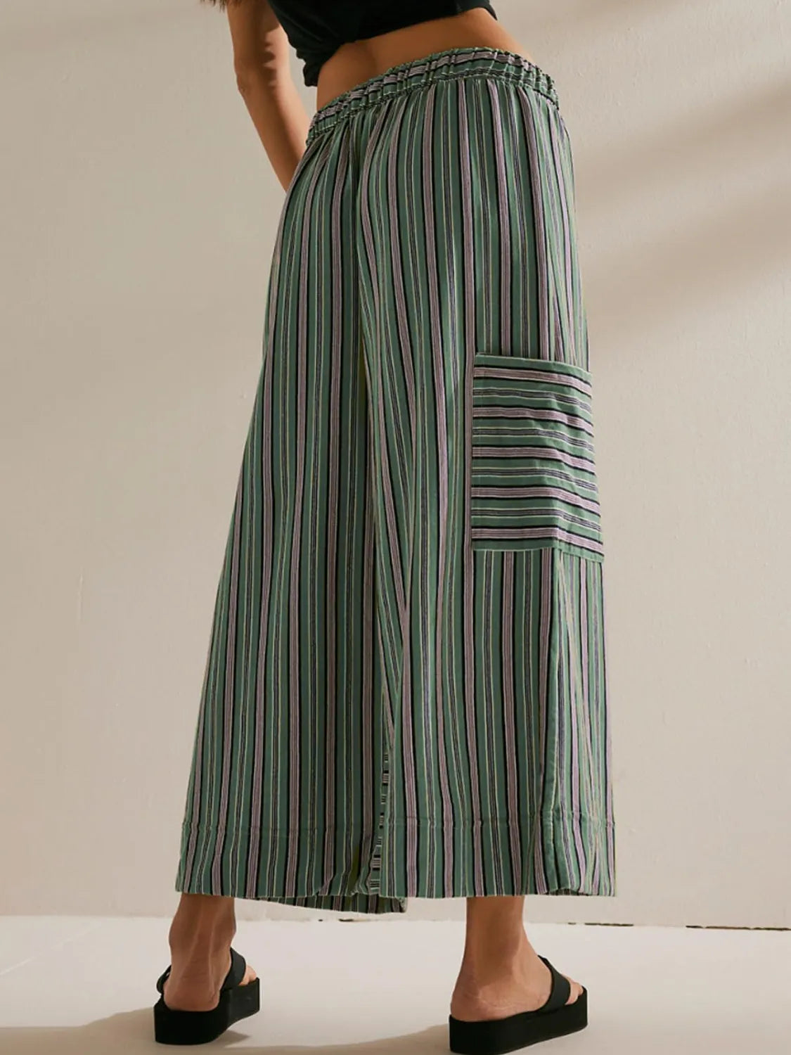Green striped wide-leg pants with elastic waist and patch pocket detail