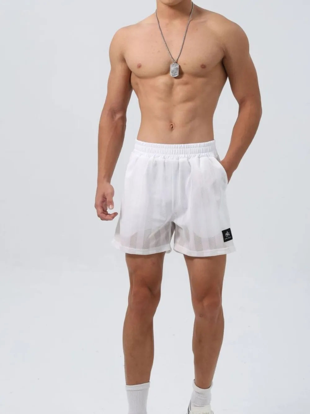White elastic waist mesh shorts with drawstring and small logo tag