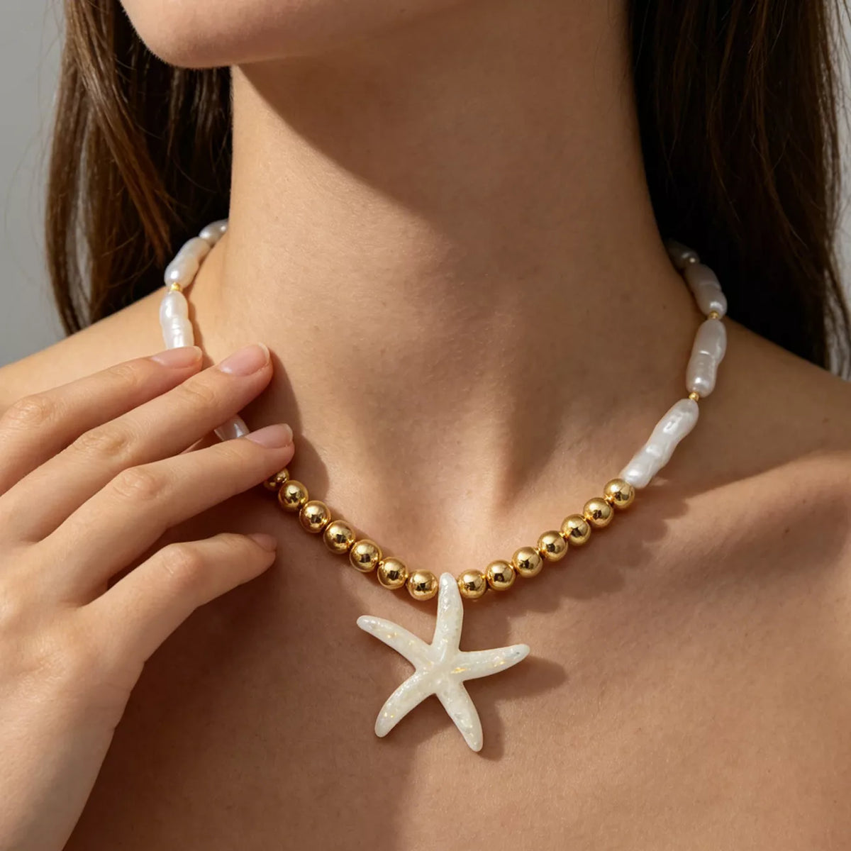 Starfish pendant necklace with alternating pearl-look beads and gold-tone beads